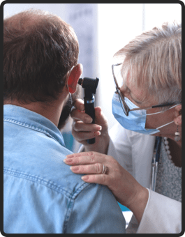 Doctor performing an ear examination on a patient, highlighting the importance of hearing health and regular checkups.